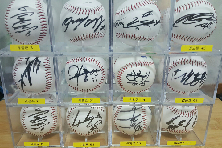 Collection of autographed baseballs in display cubes